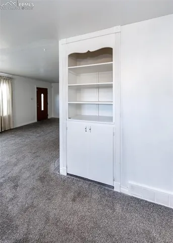 a view of an empty room with a closet