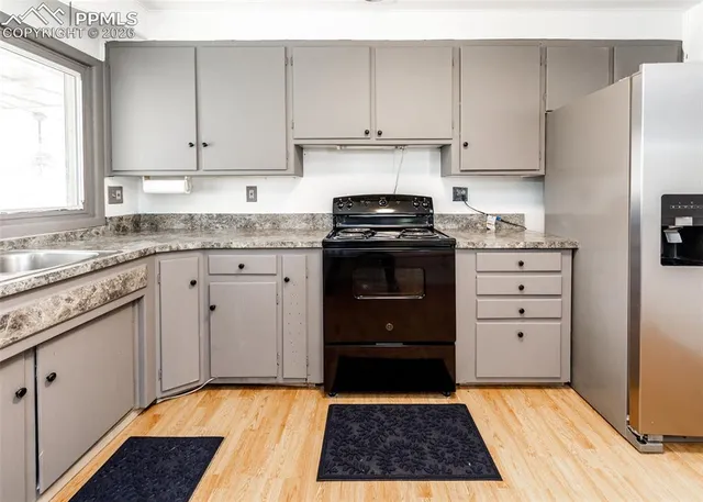 a kitchen with a stove a sink and a refrigerator