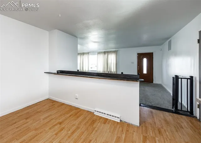 wooden floor in an empty room with a window