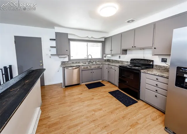 a kitchen with granite countertop stainless steel appliances and wooden cabinets