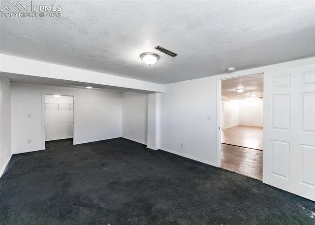 an empty room with closet and wooden floor