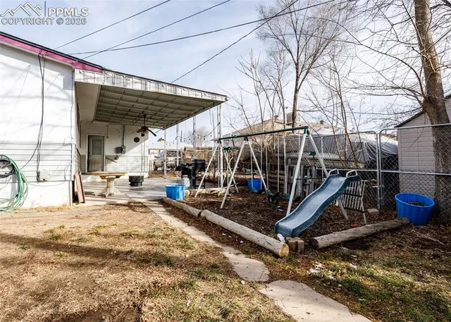 a view of roof deck with wooden fence and a floor to ceiling window