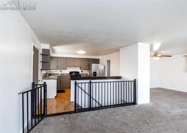 a view of a kitchen with a table and chairs