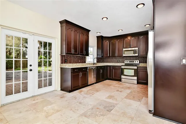 a kitchen with stainless steel appliances granite countertop a stove and a refrigerator