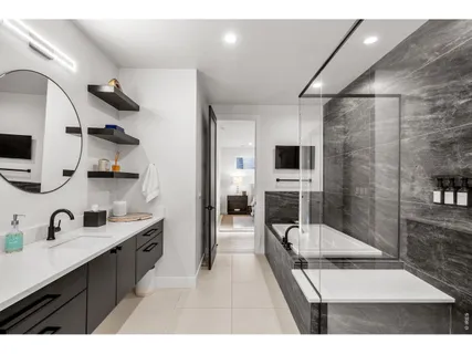 a bathroom with a sink a mirror and a shower