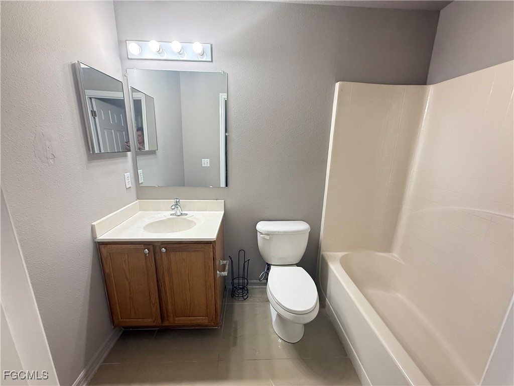 3207 54th Street West Lehigh Acres, FL 33971 - Photo 11 of 13 a bathroom with a sink toilet and shower