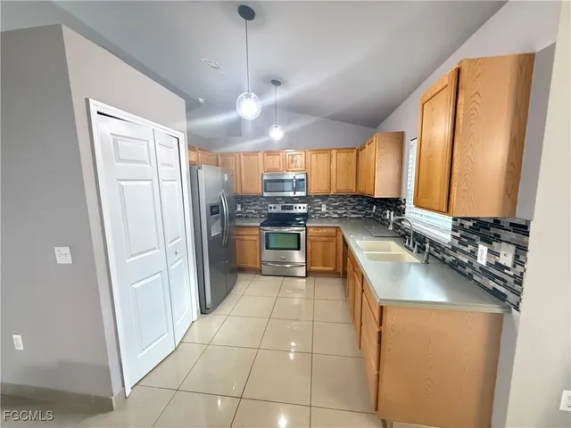 a kitchen with a refrigerator a sink and a stove