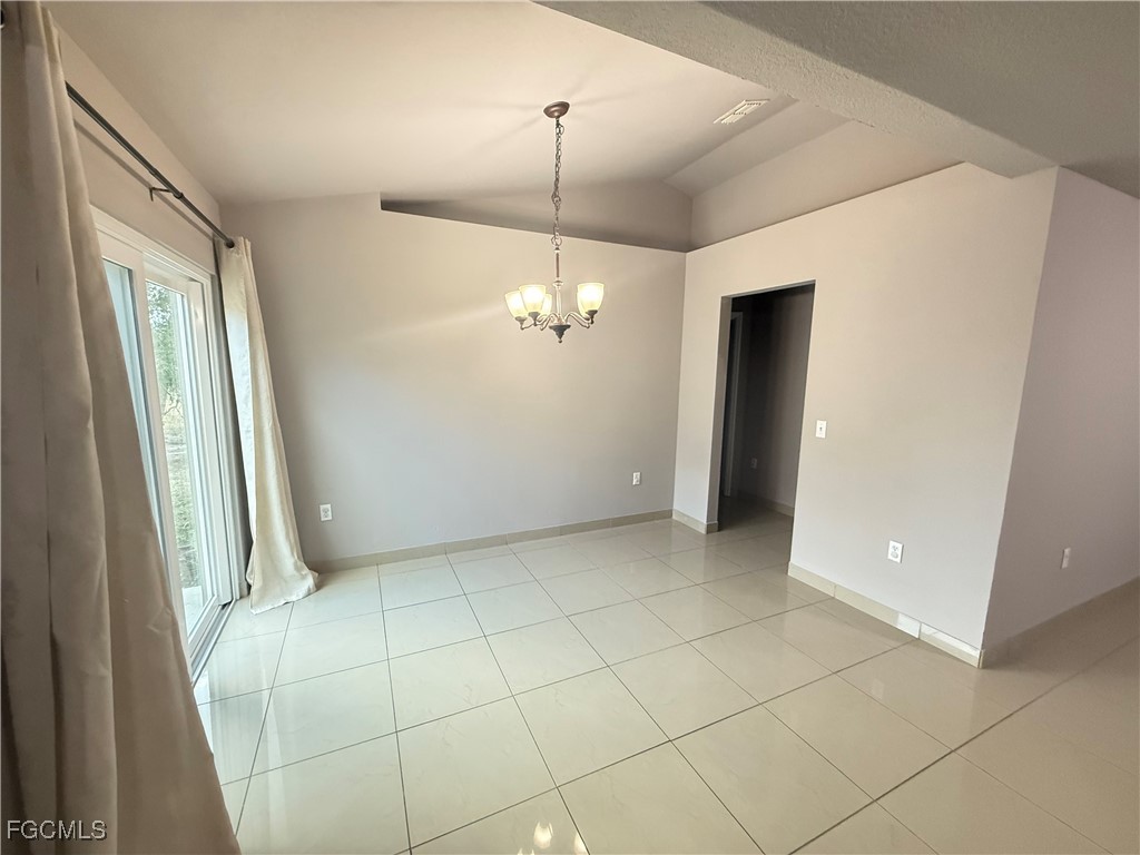 3207 54th Street West Lehigh Acres, FL 33971 - Photo 4 of 13 a view of a livingroom with a chandelier fan and windows