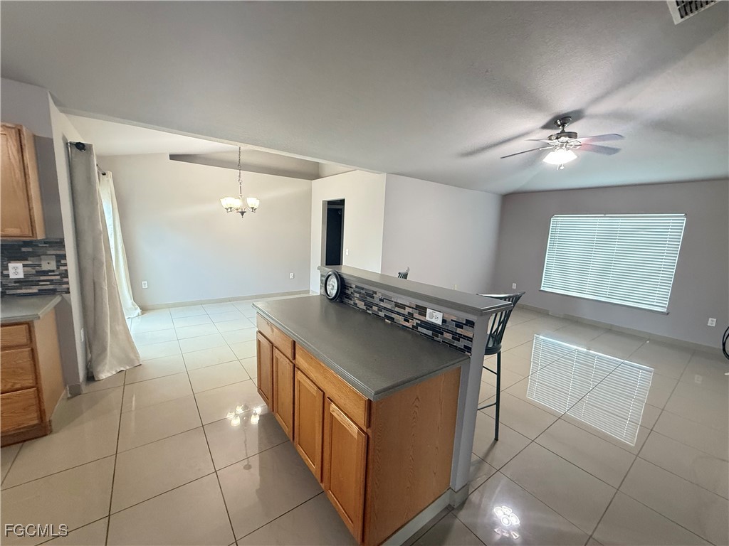 3207 54th Street West Lehigh Acres, FL 33971 - Photo 6 of 13 a kitchen with stainless steel appliances granite countertop a stove a sink and a refrigerator