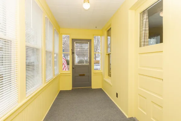 a view of a hallway with large windows