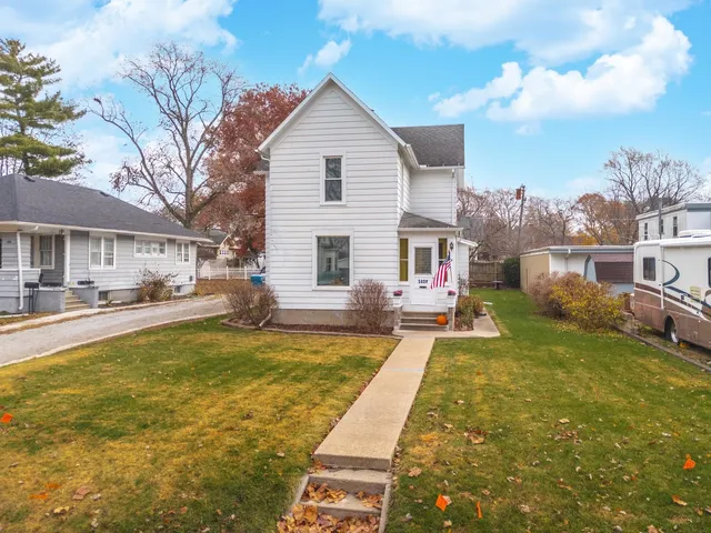 a view of a house with swimming pool and a yard