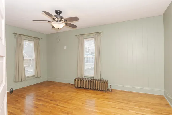 a view of a room with wooden floor and fan