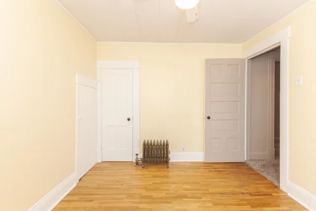 a view of a room with wooden floor
