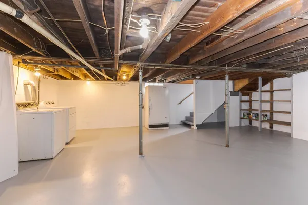 a view of empty room with wooden walls