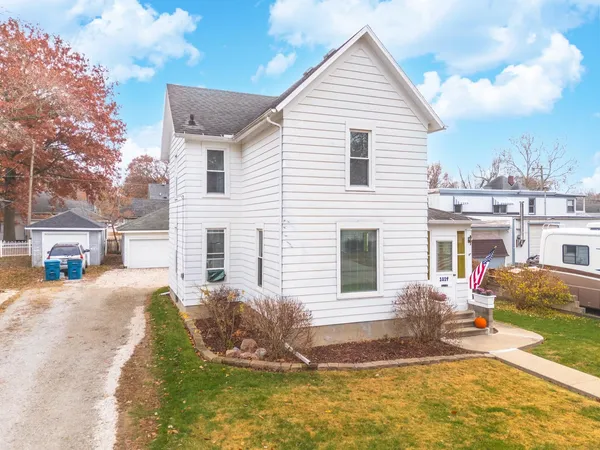 a front view of a house with a yard garage and outdoor seating
