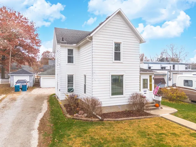 a front view of a house with a yard garage and outdoor seating