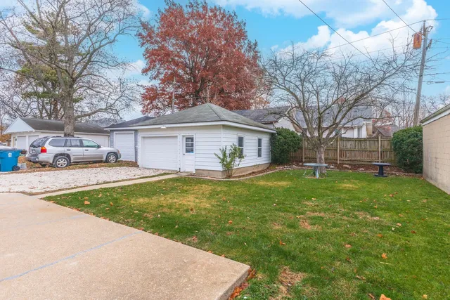 a front view of a house with a garden and yard