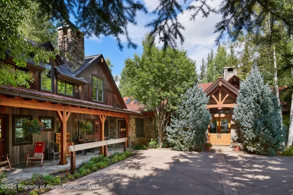 a kitchen with stainless steel appliances granite countertop a stove a sink and a refrigerator with wooden floor