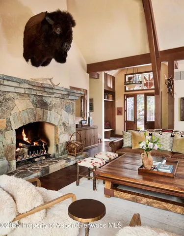 a kitchen with stainless steel appliances a stove a sink dishwasher and a dining table with wooden cabinet