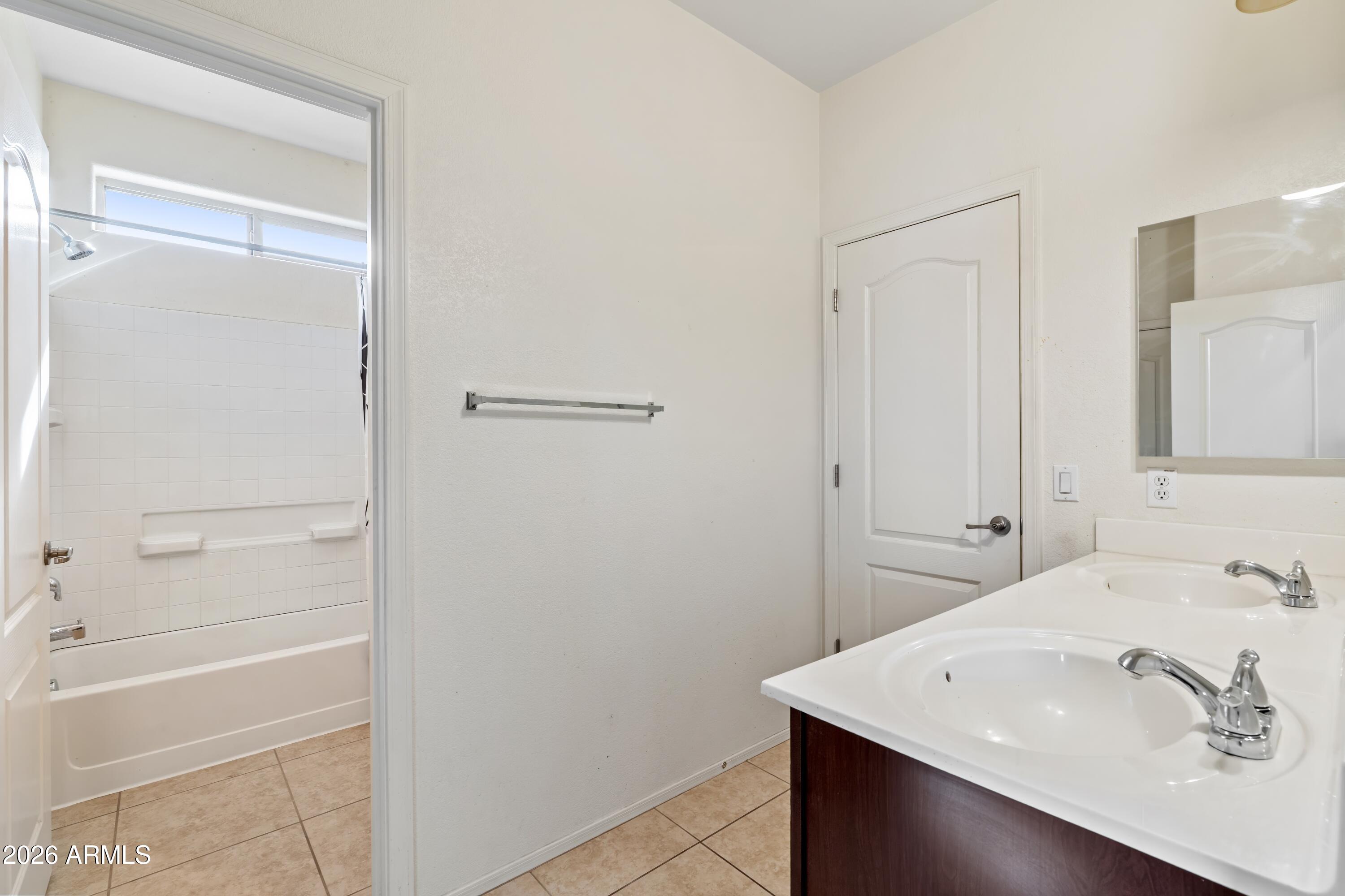 7634 West Apollo Road Laveen, AZ 85339 - Photo 25 of 34 a bathroom with a sink a shower and a mirror