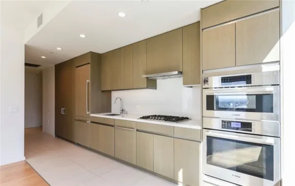 a kitchen with stainless steel appliances a stove a microwave and a refrigerator