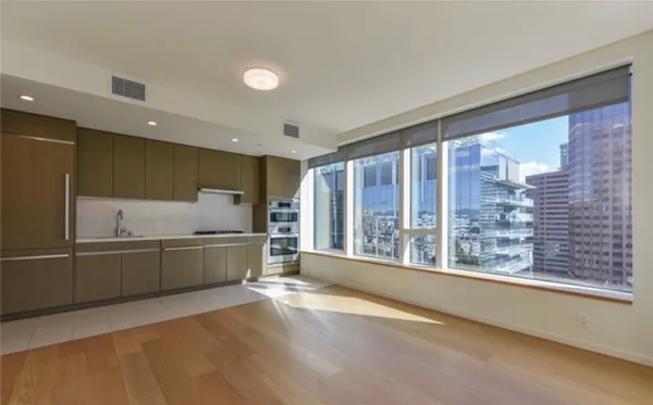 a kitchen with stainless steel appliances granite countertop a sink and cabinets with wooden floor