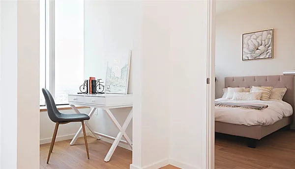 a bedroom with a bed and a chair