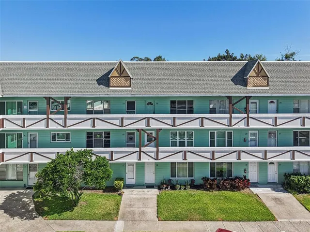 a front view of a building with a garden