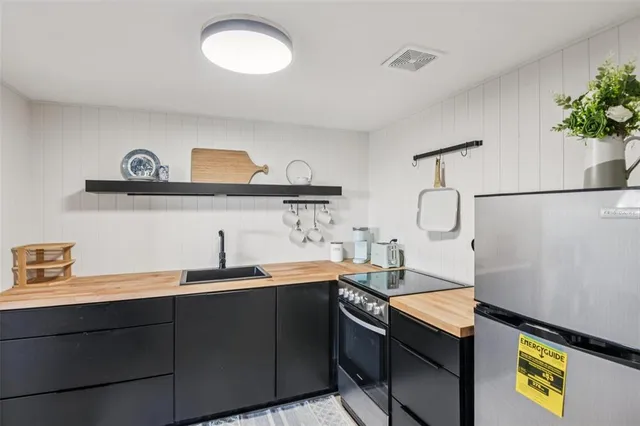a kitchen with a sink a stove and cabinets