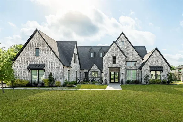 a front view of house with yard and green space