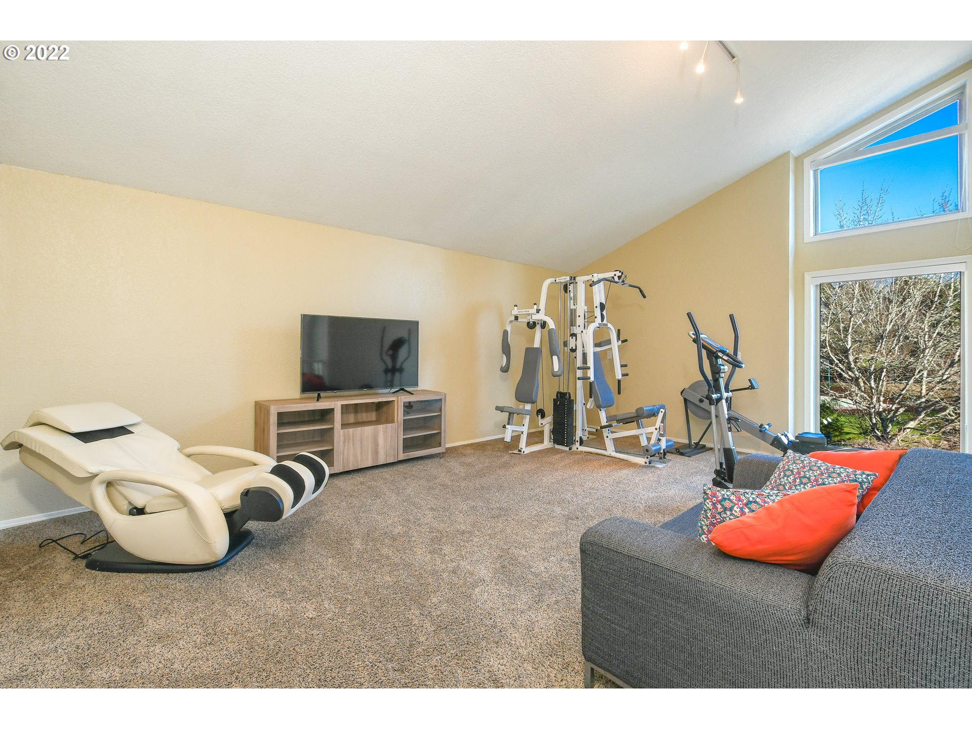 18604 Northwest 64th Avenue Ridgefield, WA 98642 - Photo 18 of 32 a living room with furniture and a flat screen tv