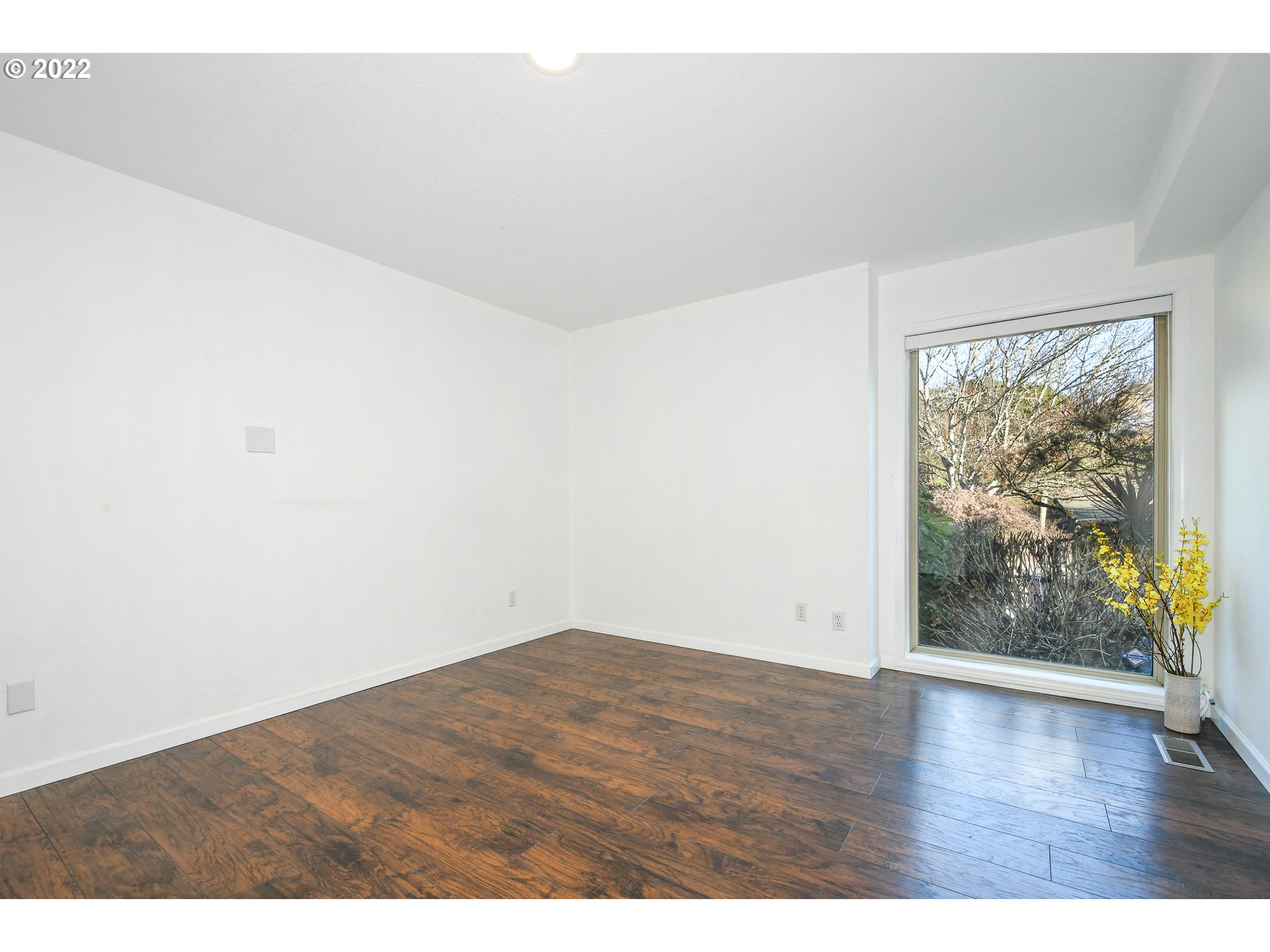 18604 Northwest 64th Avenue Ridgefield, WA 98642 - Photo 9 of 32 a view of an empty room with wooden floor and a window