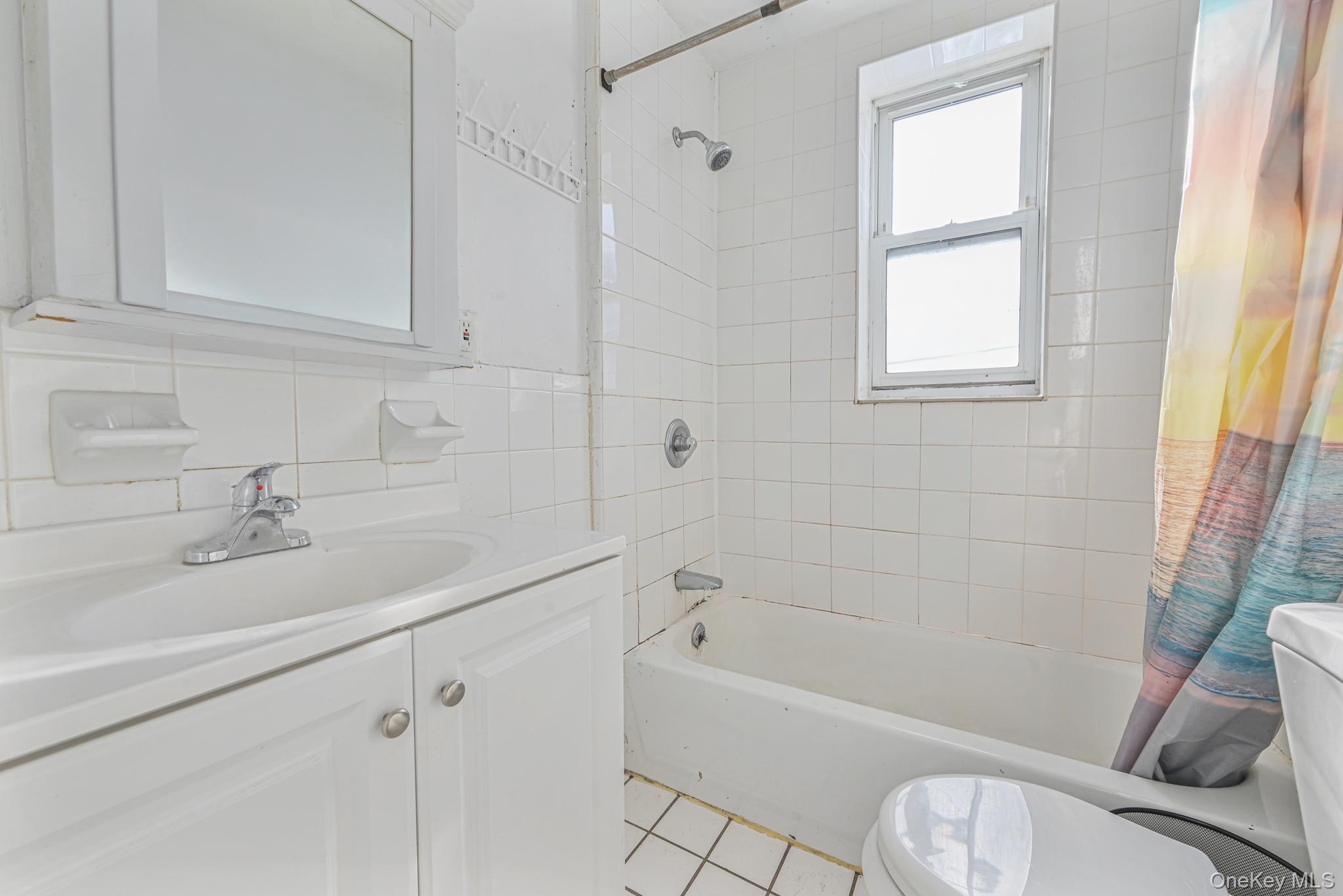 12-16 30th Drive Queens, NY 11102 - Photo 8 of 34 a bathroom with a bathtub sink and toilet