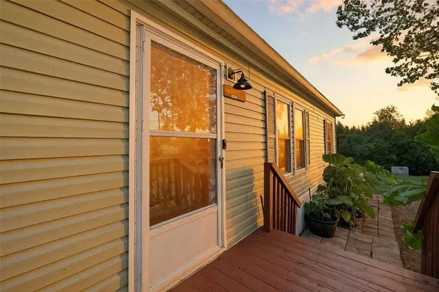 a view of balcony with wooden floor and fence