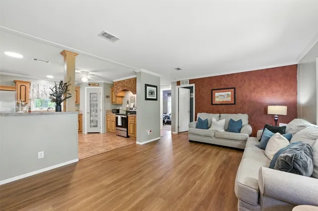 a living room with furniture and a wooden floor