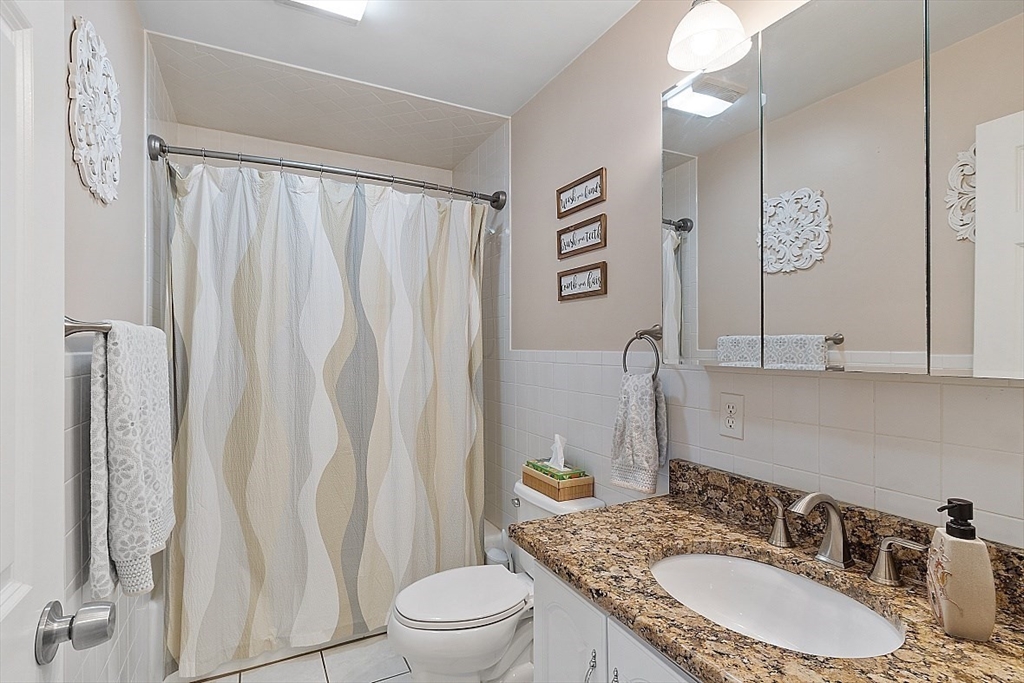 159 Judge Road Lynn, MA 01904 - Photo 16 of 41 a bathroom with a granite countertop sink vanity mirror and toilet
