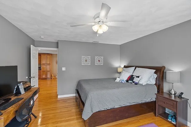 a bedroom with a bed and wooden floor