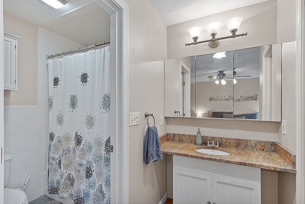 159 Judge Road Lynn, MA 01904 - Photo 23 of 41 a bathroom with a granite countertop sink a shower and a mirror