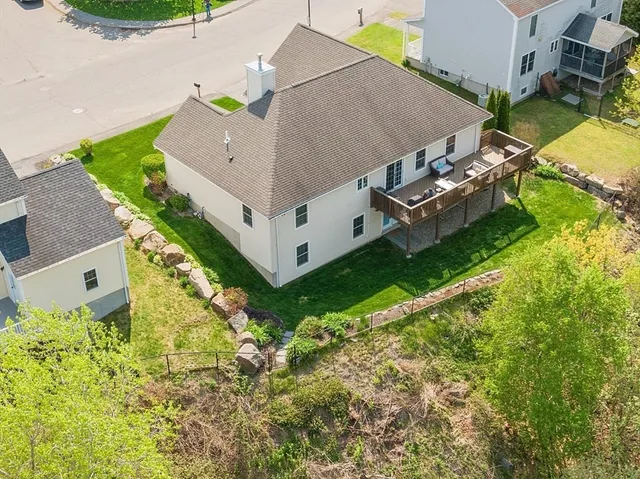 an aerial view of a house with a yard