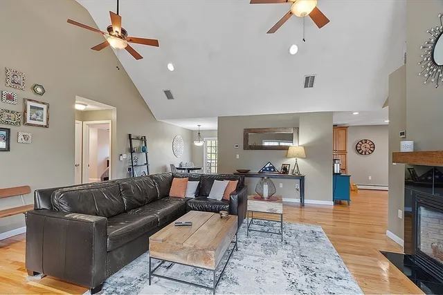 a living room with furniture and wooden floor