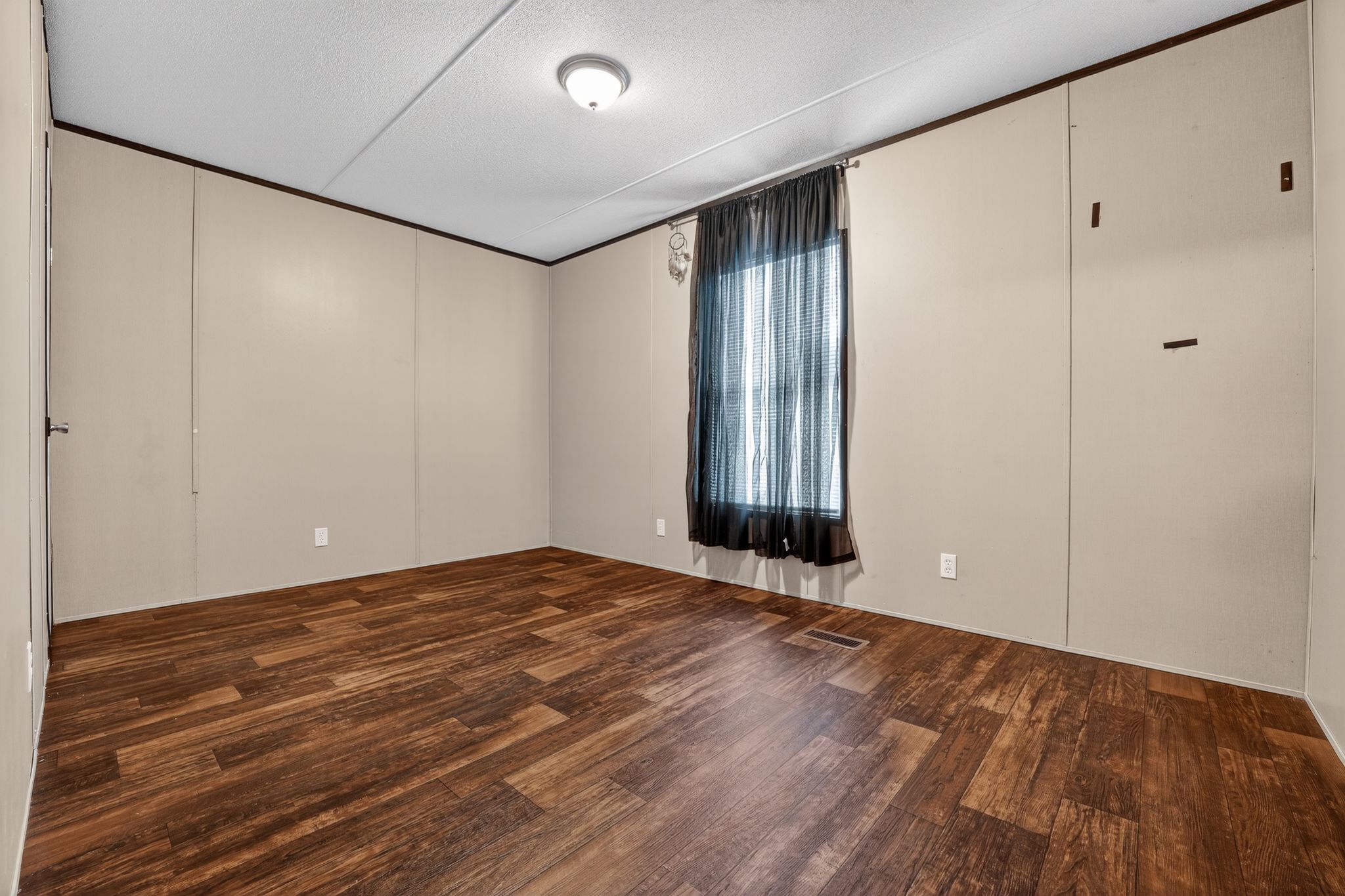 16 4th Street Maxwell, TX 78656 - Photo 14 of 35 a view of an empty room with wooden floor