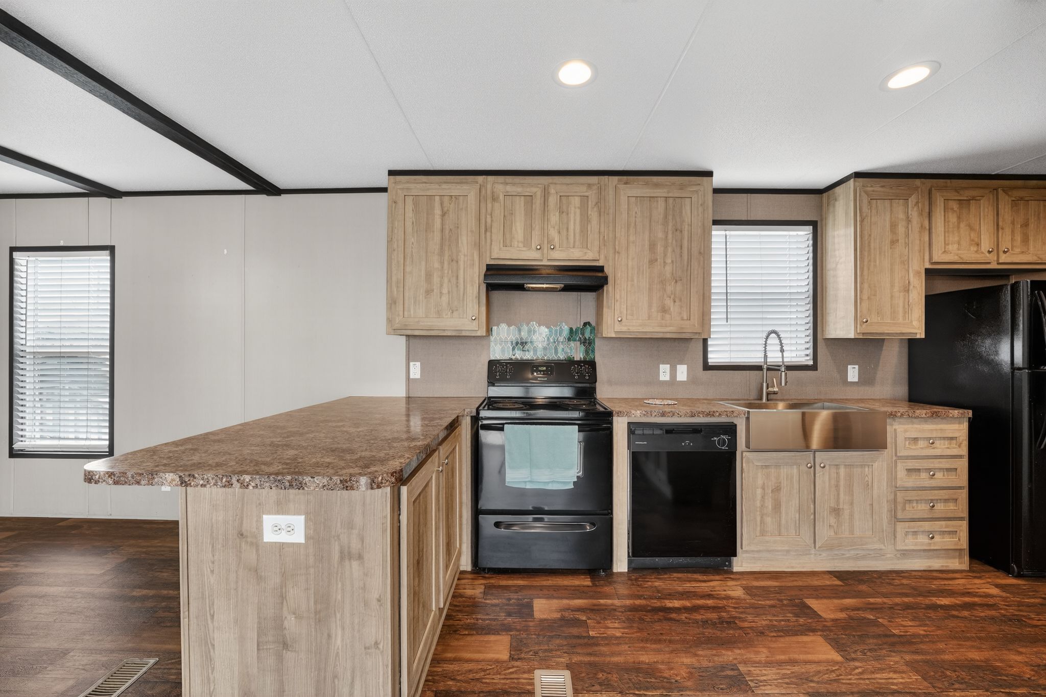 16 4th Street Maxwell, TX 78656 - Photo 20 of 35 a kitchen with kitchen island granite countertop a stove top oven sink and cabinets