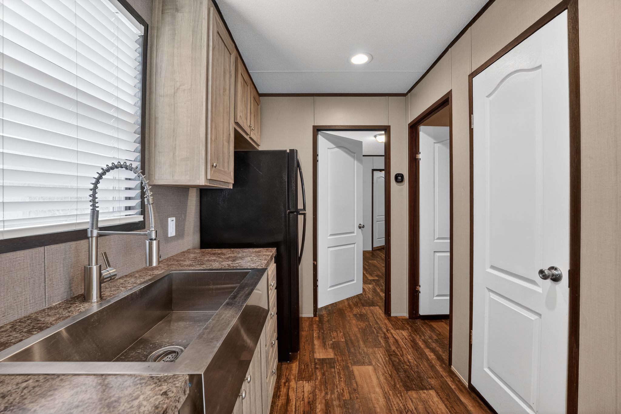 16 4th Street Maxwell, TX 78656 - Photo 21 of 35 a kitchen with a refrigerator sink and cabinets