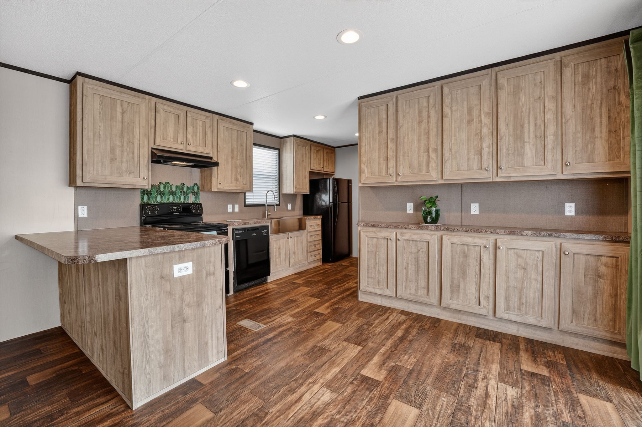 16 4th Street Maxwell, TX 78656 - Photo 25 of 35 a kitchen with kitchen island granite countertop wooden cabinets and white appliances
