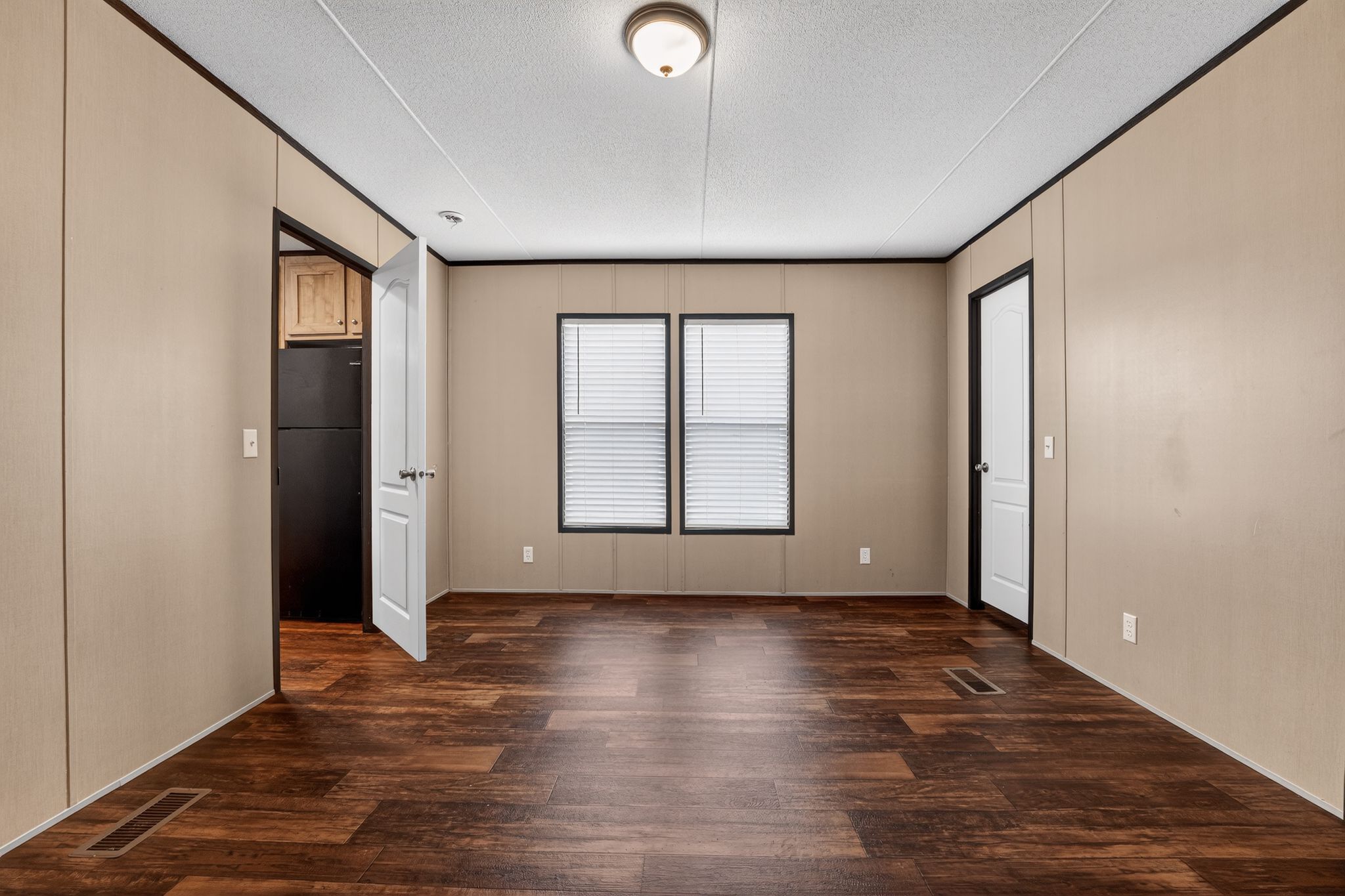 16 4th Street Maxwell, TX 78656 - Photo 28 of 35 an empty room with wooden floor and windows