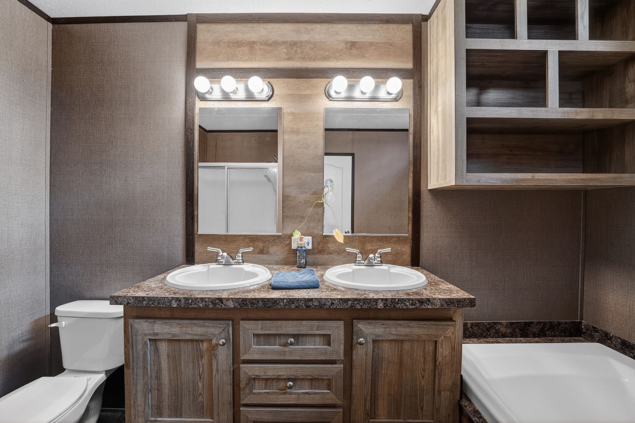 16 4th Street Maxwell, TX 78656 - Photo 32 of 35 a bathroom with a granite countertop sink a toilet and a mirror