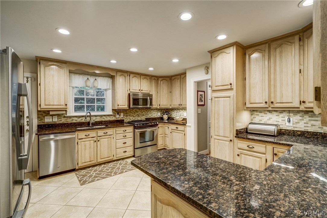 3901 Cheyenne Road Richmond, VA 23235 - Photo 11 of 49 a kitchen with stainless steel appliances granite countertop a stove a sink and a refrigerator