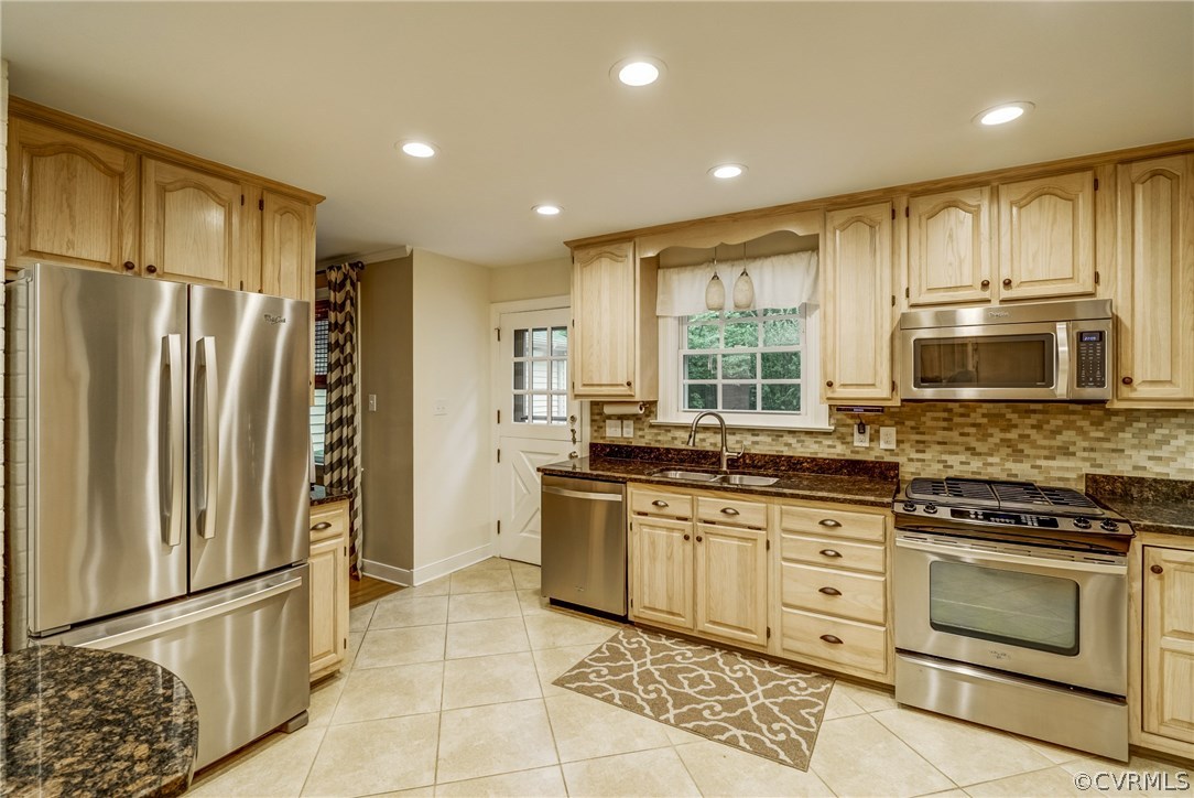 3901 Cheyenne Road Richmond, VA 23235 - Photo 12 of 49 a kitchen with stainless steel appliances granite countertop a stove a sink and a refrigerator