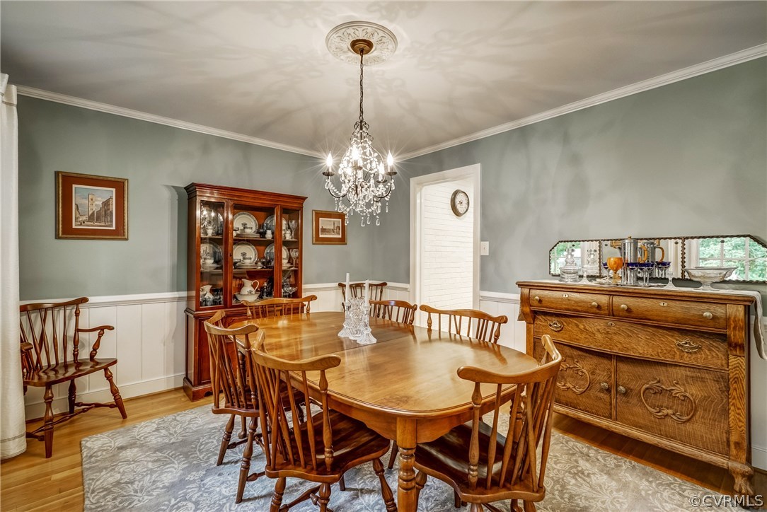 3901 Cheyenne Road Richmond, VA 23235 - Photo 3 of 49 a view of a dining room with furniture and a chandelier