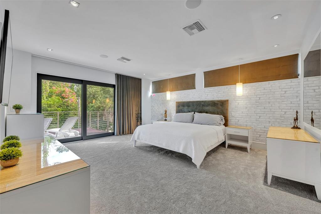 1411 Nottingham Street Orlando, FL 32803 - Photo 24 of 47 a spacious bedroom with a large bed and a balcony